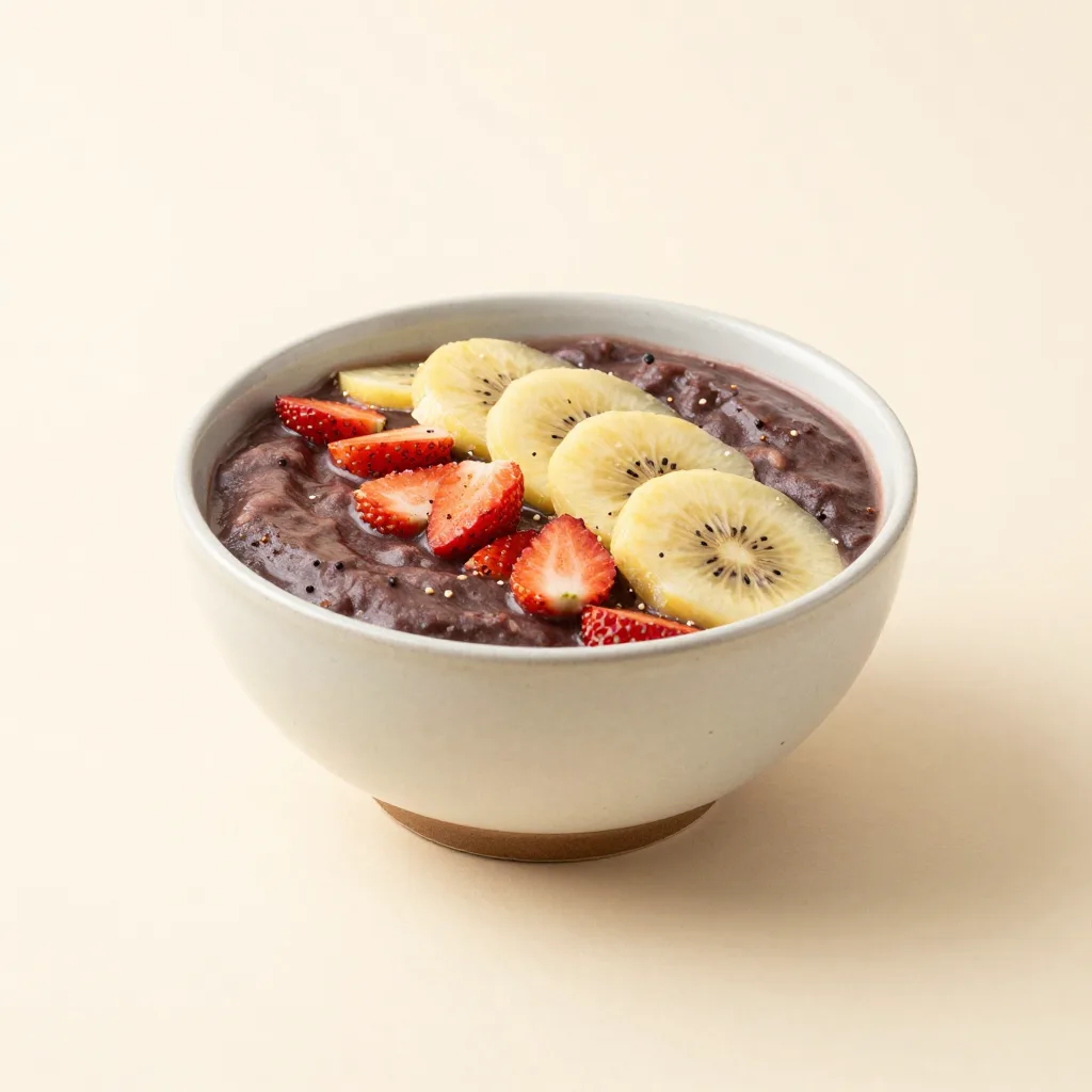 An açaí bowl set with a ceramic bowl on a light background